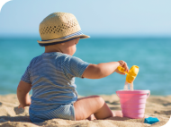 Toddler playing on the beach